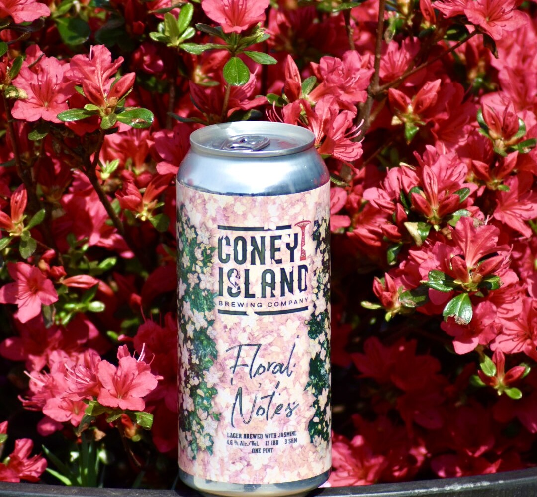 BEER CAN IN FRONT OF FLOWERS