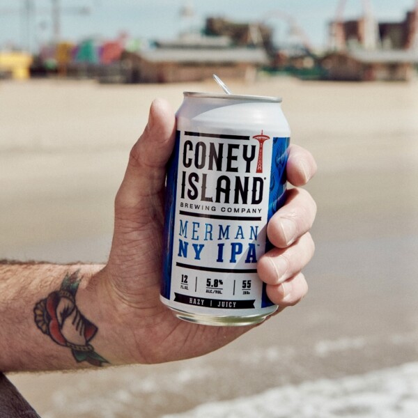 BEER CAN IN HAND ON BEACH